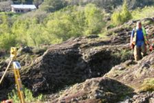 Land Surveying Example - Surveyor Hiking Down Rocky Hill