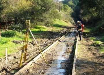 Surveyor on Sonoma-Marin Area Rail Transit Track