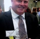 David Brown holding 'Leading CFO" Award
