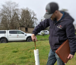 Engineer testing groundwater levels for septic permit